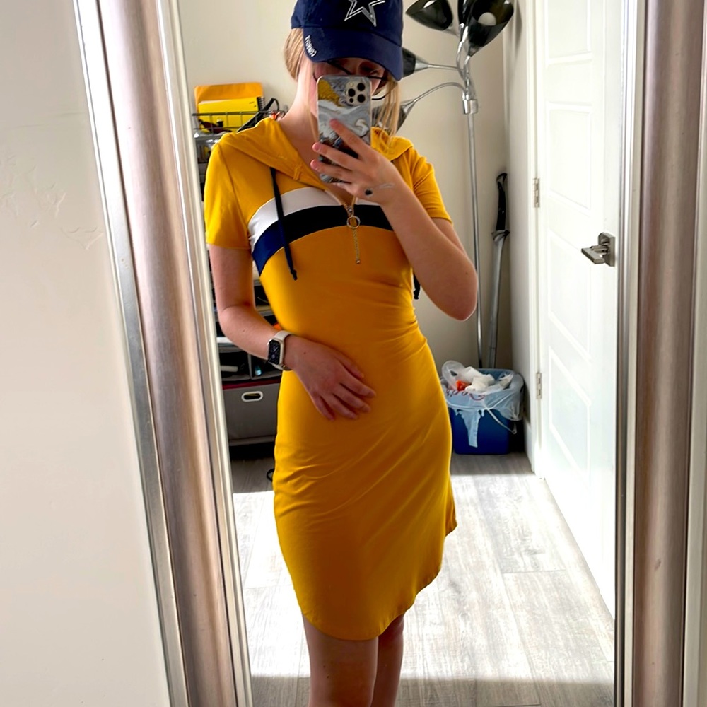 Form fitting yellow T-shirt dress with front zipper.
